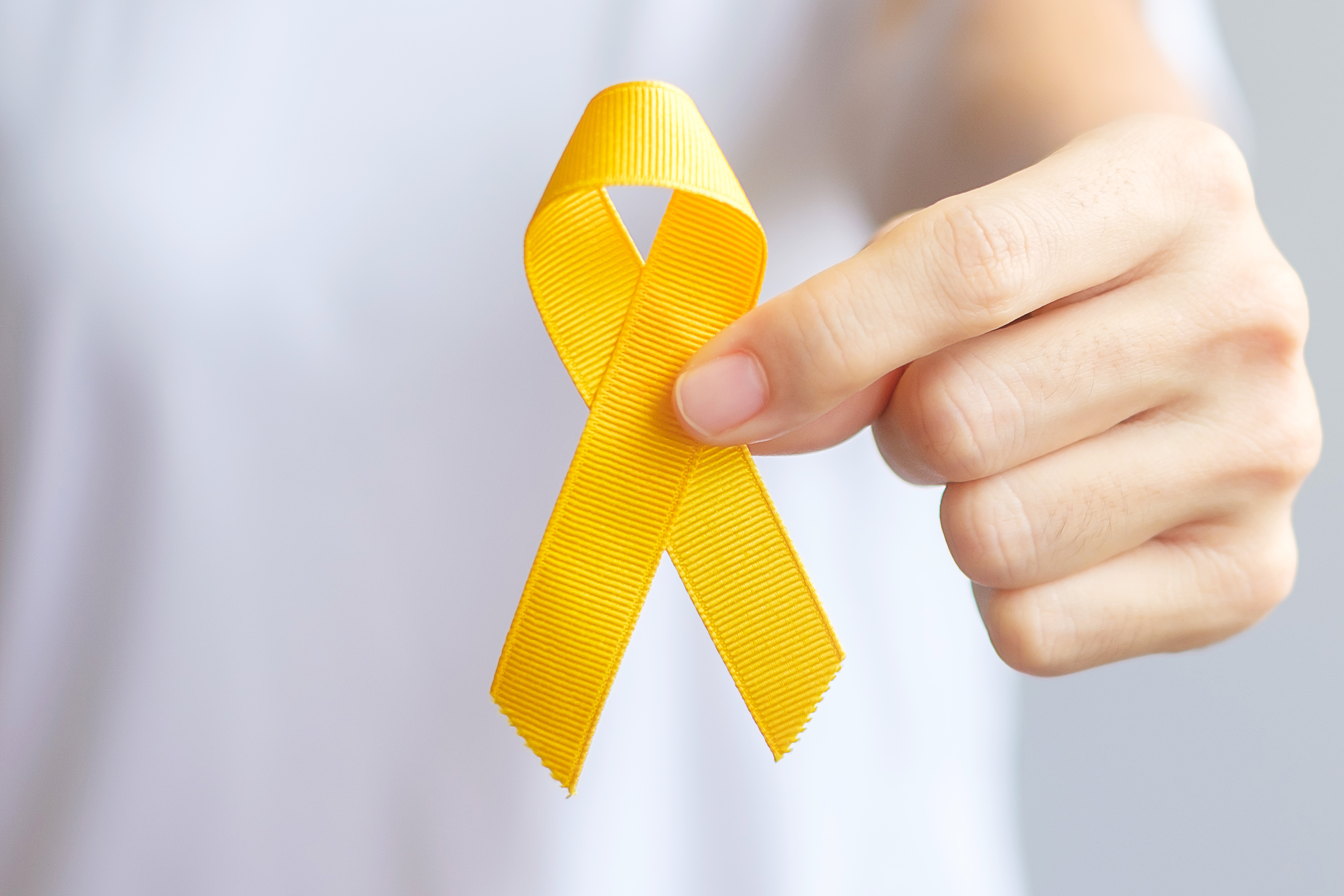 suicide prevention day sarcoma bone bladder and childhood cancer awareness month yellow ribbon for supporting people living and illness children healthcare and world cancer day concept